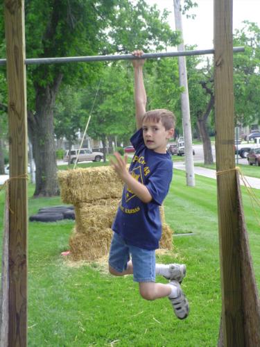 Shaun - This is Shaun, he is a new Tiger Cub. He has been waiting 3 years to be old enough to officially join cub scouts. His big brother is a Webelos and both his mom and dad are trained volunteers. This is part of the obstacle course at the 2007 Scout Show. Shaun is a monkey sometimes, can you tell?