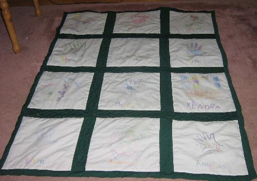 Wallhanging  - This is a memory quilt that I made for my friend Barb. She lives in Montreal with her husband and 8 children. At the time that I was constructing the wall hanging she just had 6 chidren .