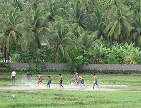 kerala monsoon - kids playing in the rain