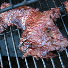 G's Flank Steak Marinade -  'This is a marinade for any type of steak, but works well for tougher cuts when left for a couple of days.'   PREP TIME 15 Min  COOK TIME 20 Min   READY IN 6 Hrs 35 Min   INGREDIENTS: 1/2 cup soy sauce 2 tablespoons brown sugar 2 tablespoons lemon juice 2 tablespoons olive oil 2 cloves garlic, minced 1 tablespoon minced onion 1 teaspoon ground ginger 1/2 teaspoon black pepper 1 (1 1/2-pound) beef flank steak   DIRECTIONS: 1. In a shallow bowl, combine soy sauce, brown sugar, lemon juice, olive oil, garlic, onion, ginger and pepper. Coat steak with marinade, cover, and refrigerate for at least 6 hours. 2. Preheat an outdoor grill for high heat, and lightly oil grate. 3. Grill steak for 7 to 8 minutes per side, or to desired doneness.