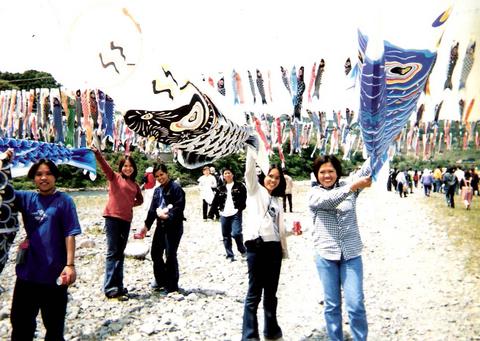 hanging fish kites - having fun decorating fish kites on the riverside...