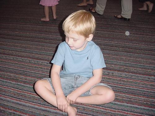 Sitting posture - a boy with legs crossed sitting on the floor