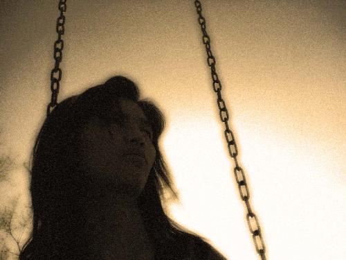Swinging alone - A sad sepia picture. Me as a model. Taken at the park.