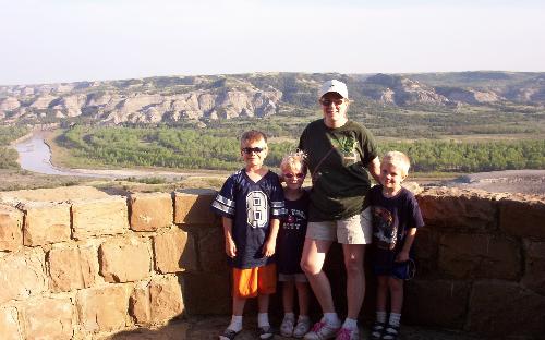 Mom and children posing at the Theodore Roosevelt  - My children and I posing for pic at the Theodore Roosevelt National Park overlooking the Oxbow Bend River that runs right through it.