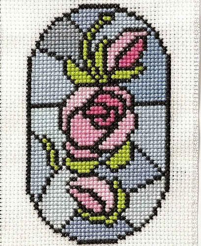 Roses on a stained glass window - A bookmark that I cross-stitched featuring roses on a stained glass window.
