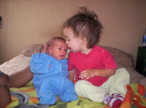 my boys - My older son ADORES his baby brother and smothers him in kisses all day long. The poor little guy is constantly covered in spit from the open-mouthed kisses that my 17 month old gives him!