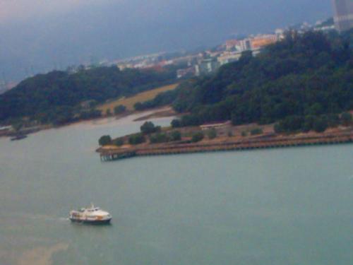 A small boat in the middle of it all. - The boat makes it view like it some kind of a sanwich filling coz it is right in the middle of a spectacular view from whare I am.