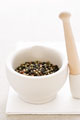 Peppercorns  - Peppercorn in a mortar waiting to be crushed by a pestle ..