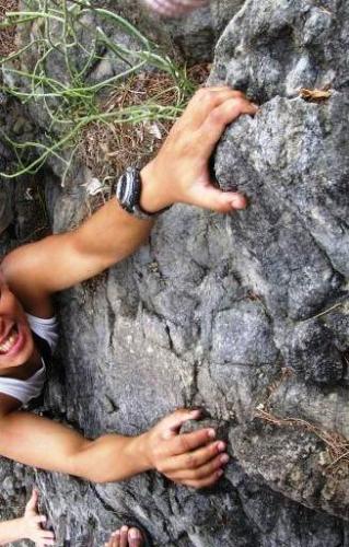 Rock Climbing - A rock climber struggling to go up.