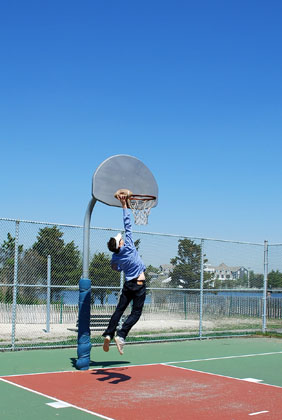 play basketball - Trying to put the ball in to the basket, while playing basket ball.