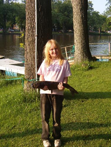Caroline and her 6+ pound catfish - This is a pic of our daughter and the catfish she caught while camping Memorial weekend. 9yrs old and she fought this s*cker for a good 20min. in a boat to reel it in. Dad helped with the net once it got close enough.