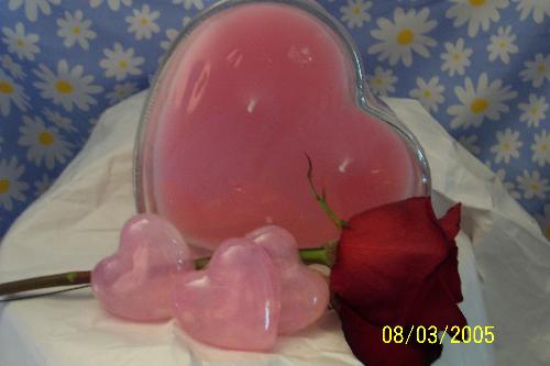 Candle and soap set - This is a picture of a rose scented candle and soap set I made for a customer. He ordered it for his wife for their anniversary. She loves candles and to take long hot baths. He latered order the bath salts and bubble bath to go with it after I had taken the picture.