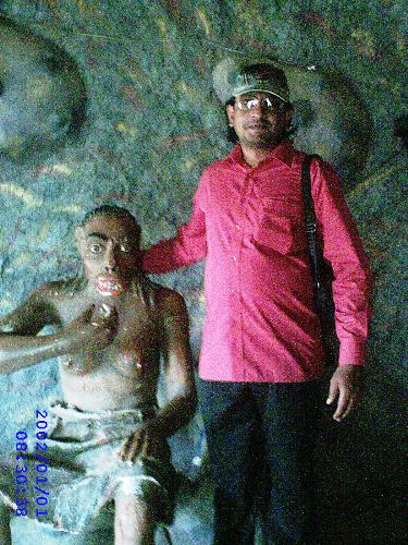 art, old and new - a life size POP model of a pre-historic man in a cave, part of a prehistory meuseum in a Rajasthani Holiday Resort in Hyderabad, India.