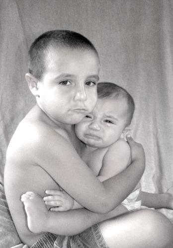 parenting - This is a picture my sister took of my boys when they stayed with her for a few days a couple of years ago. Jr. the baby was not happy, and did not want to cooperate so my sis, told Anthony the oldest, to look like he was crying too...i love the end result of it.
