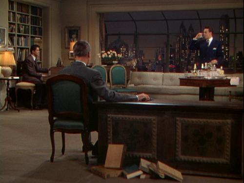 A scene from Hitchcock thriller Rope - Rope is a classic Hitchcock thriller starring James Stewart. Synopsis: two young men kill prep-school friend, just for the thrill of it, and challenge themselves by inviting friends and family to their apartment afterward—with the body hidden on the premises. Hitchcock's first color film was shot in ten-minute takes to provide a seamless flow of movement, but it remains today what it was then: an interesting, highly theatrical experiment. Inspired by the real-life Leopold-Loeb murder case. Patrick Hamilton's play was adapted by Hume Cronyn and scripted by Arthur Laurents.