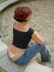 Low rise jeans - Girl in low rise jeans with her panties showing.