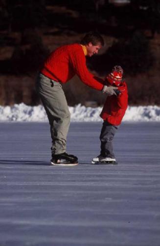Father's Helping Hands - This photo shows a father helping his child during ice skating...a father who cares is always willing to lend a hand...