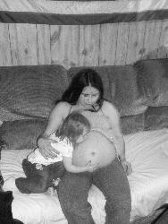 me pregnant - me and my pregnant belly with my oldest daughter trying to kiss it.