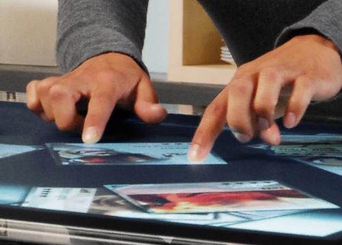 Microsoft surface - Hands working on a microsoft surface table