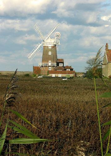 Cley Mill, Norfolk - Cley Windmill dates from the early 18th Century and is a well-known landmark on the North Norfolk Coast. The Mill itself has been converted into a guesthouse of great character and charm. The old stables and boathouses are now stylish bedrooms or self-catering retreats for independent holidaymakers.  The Mill stands on the north side of the village within walking distance of the excellent and unusual village shops. It overlooks the sea, the salt marshes and Cley Bird Sanctuary, with Blakeney Harbour in the distance.
