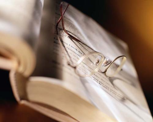 Novel and Reading Glasses - This photo depicts a novel and reading glasses....necessary supplies for using the commode...awww..... a few minutes of total privacy....