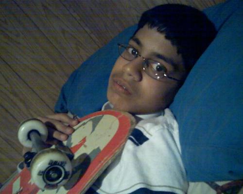 Myself - This is a picture of myself. I'm holding my first skateboard.