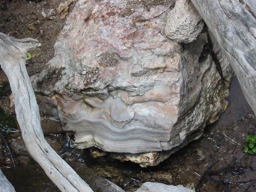Huge Piece of Quartz - This is a huge piece of red and pink quartz we found on a recent hiking trip. The rock most likely weighed over 100 pounds at least! This was down in a wash or drainage area in the mountains of southwest New Mexico.