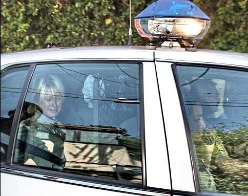 Paris in Police Car - Paris Hilton rides in a police car on her way back to jail on June 8, 2007