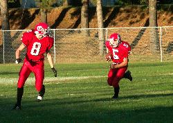 Football player running back a kick off - This is a photo I took of a local football game.  I caught this just right and was able to see his face.  This one made the paper and I printed a large photo for the boys parents and they now display it in their business.  It has genterated increased interest in my photos.