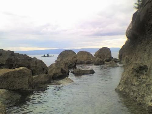 rocky cove - taken with VGA, at dusk...that's a banca in the background