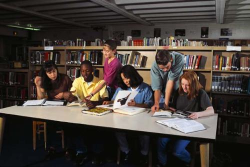 Kids Doing Research at the School Library  - This photo depicts students doing research at the school library.....there are often many goode reference material available for this purpose..