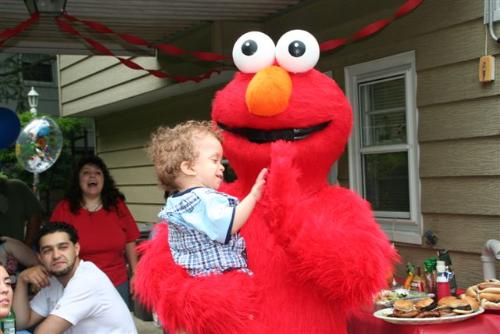 Logan and Elmo - My son is giving his special party guest a high five.