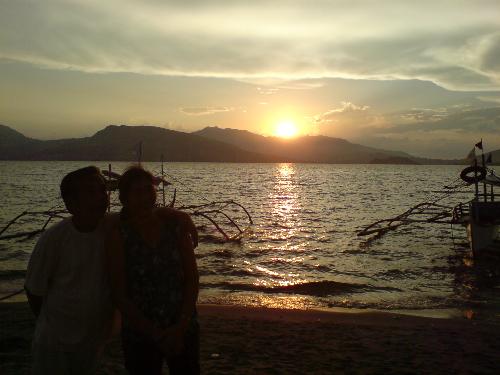 Sunset by the beach - this is a silhoutte of my parents standing by the beach.
