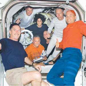 crew members aboard International Space Station - Sunita Williams (centre) alongwith other crew members aboard International Space Station give a ‘thumbs-up’ signal following a successful session of extravehicular activity while space shuttle Atlantis docked with the station.