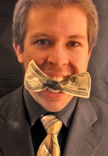 How far will you go to impress? - A picture of a man with money in his mouth. Taken from http://farm1.static.flickr.com/40/120973041_ba329b46d7.jpg?v=0 .