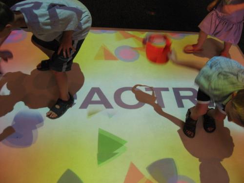 Reactrix - This is their logo with various geometric shapes that moved about and the kids 'killed' them breaking them into smaller pieces.