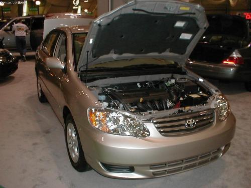 Corolla 2003 @ LV - Few cars have a heritage as long as Toyota’s popular compact. The Corolla has been on the U.S. market since 1966. More than 25 million units have been sold in 142 countries, and that makes the Corolla the best-selling passenger car of all time. Toyota dealers sold 245,023 eighth-generation Corollas in the United States during 2001, according to Automotive News. It has been Toyota’s second-best seller behind only the midsize Camry. Toyota’s production goal for the redesigned 2003 model is a little more modest: 230,000 units. Changes for the popular, front-wheel-drive sedan’s next generation are moderate but meaningful. Engine output has increased by 5 horsepower, and a new, low-restriction catalytic converter is used in the exhaust system. The car is also a little larger than before. A new automatic transmission boasts fewer parts and reduced friction, which promises less than a 1-mpg fuel-economy penalty when compared with the manual-transmission model. Steering is claimed to be more responsive and linear, and braking is more precise. A higher hip point is supposed to ease entry into the vehicle, and the front seats have been moved farther apart.