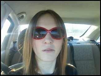 Me in Dallas - A few months ago my fiance and I thought it would be a good idea to go visit my sister in Dallas. She and my brother-in-law live there. It's not too far from where I live, about a five hour drive.   While I was there, we had a blast. One day we went to a mall and goofed off for awhile. While we were there we went to Claire's and got some goofy sunglasses, then we went to her job so that I could meet her co-workers. Apparently she gave them all very high expectations of me before I ever thought about going to visit. I don't know if I was a let-down or not, ha ha.  Anyway, we spent a lot of time taking pictures of ourselves, or driving around town with our music blaring. This was one of those random phone shots.