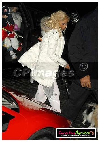 chrissy - christina wearing a white coat with fur on the collar