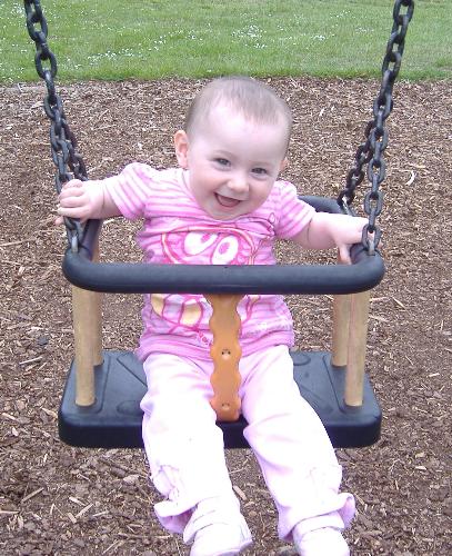 baby girl thorougly enjoying a swing. Doesn't she  - baby girl thorougly enjoying a swing. Doesn't she look happy?