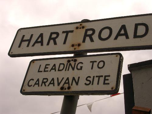 Misleading sign - Misleading sign, the road is a main artery in a busy residentila area, not an approach path to a campsite