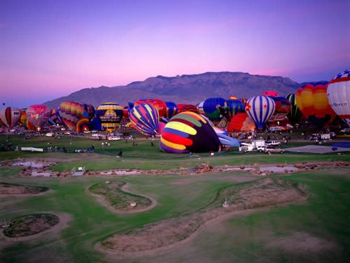 Albuquerque Internation Balloon Fiesta - Hot air balloons being inflated with the Sandia Mountians in the background.