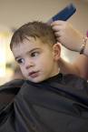 boy's haircut - A picture of a boy having his hair cut.