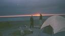 Camping on the beach - watching the sunset from a tent.