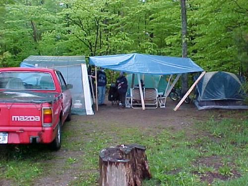 our campsite - Memorial weekend 2003. Caroga Lake State Campground. Adirondack Mts. NYS thank god for big blue tarps. we had two tents and a 12 x 12 screenhouse.