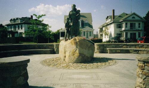 Widow's monument - This is on the board walk in Gloucester, Massachusetts. It is a statue of a woman and her children awaitng her husband to come home from see, around the statue in the pavement are tiles with the names of men who have died out at sea. Gloucester, MA was founded as a fishing village. In the background are some historic homes.