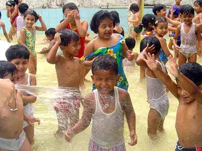 children enjoying summer - Children enjoying a splash during a summer camp.