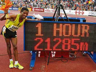 new world record - Haile Gebrselassie of Ethiopia poses in front of a board showing his new world record distance in the Hour Run event at the IAAF World Athletics Tour Golden Spike meeting in Ostrava in the Czech Republic.
