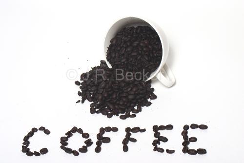 Starbucks Coffee Beans - Cup of Starbucks beans spilled out spelling coffee.