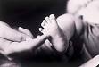 Tickling Baby's Feet - An adult finger tickling a baby's foot.